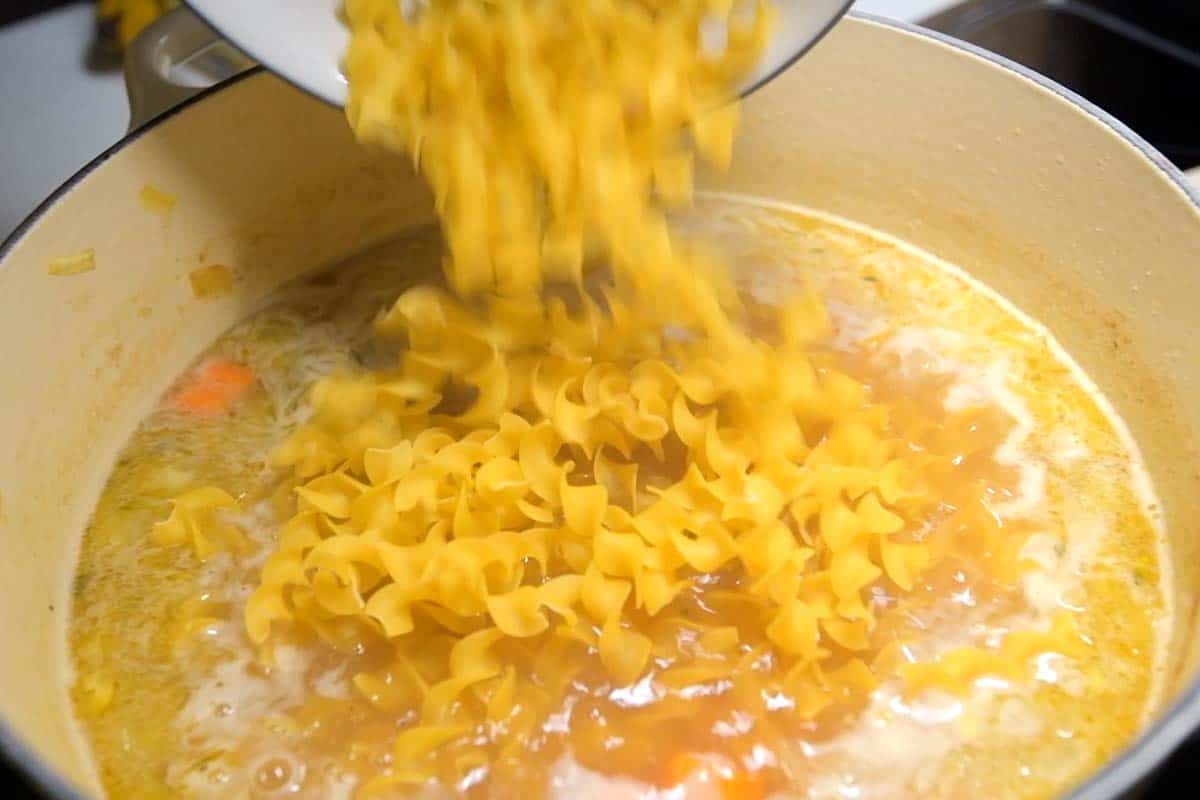 Adding noodles to a soup pot