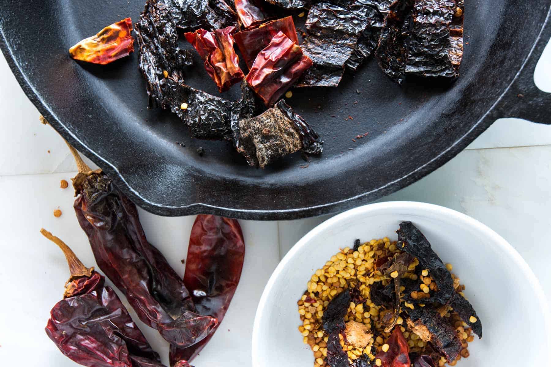 There's three simple steps for preparing the dried chiles for your own chili powder. Toasting dried chilis in a pan