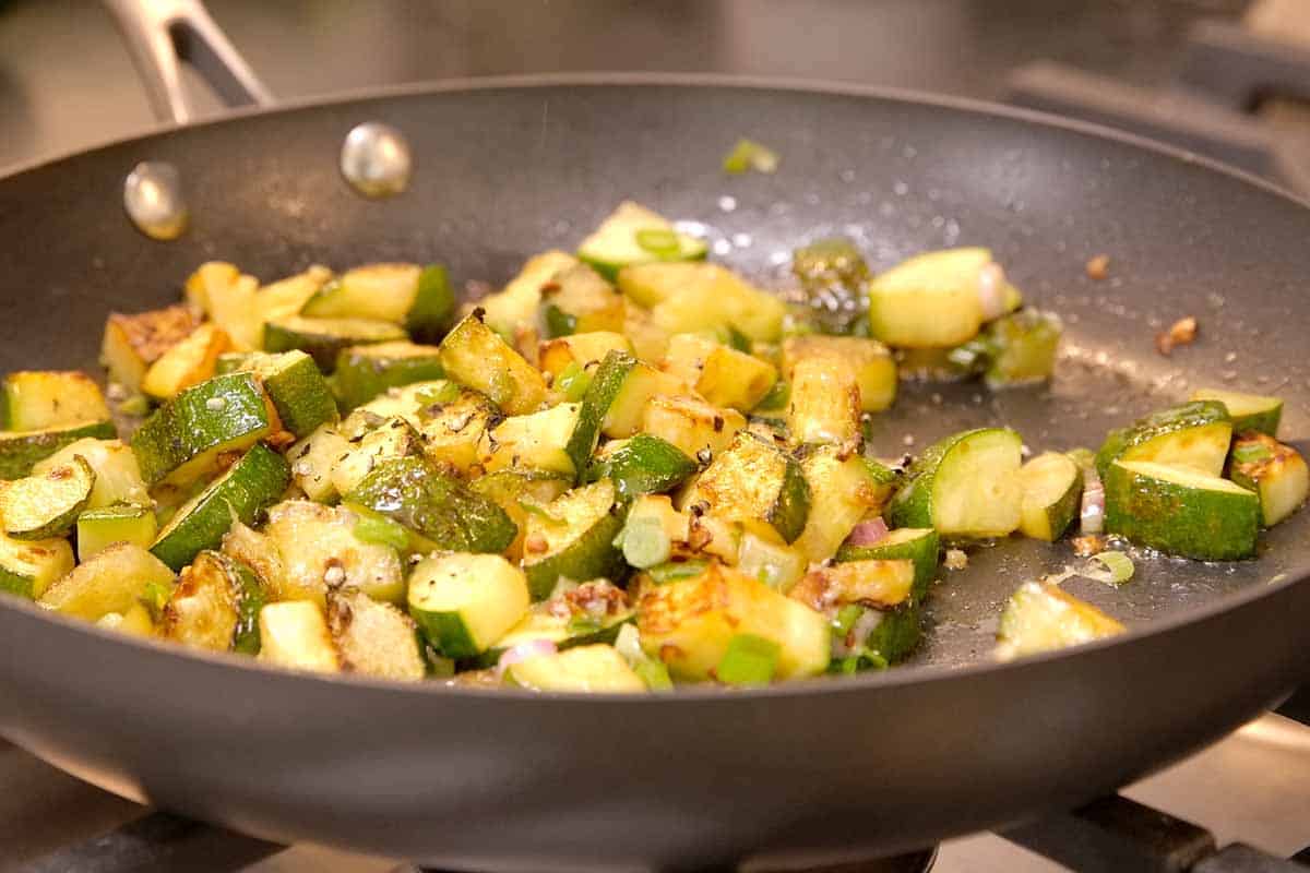 Sautéing zucchini in a pan