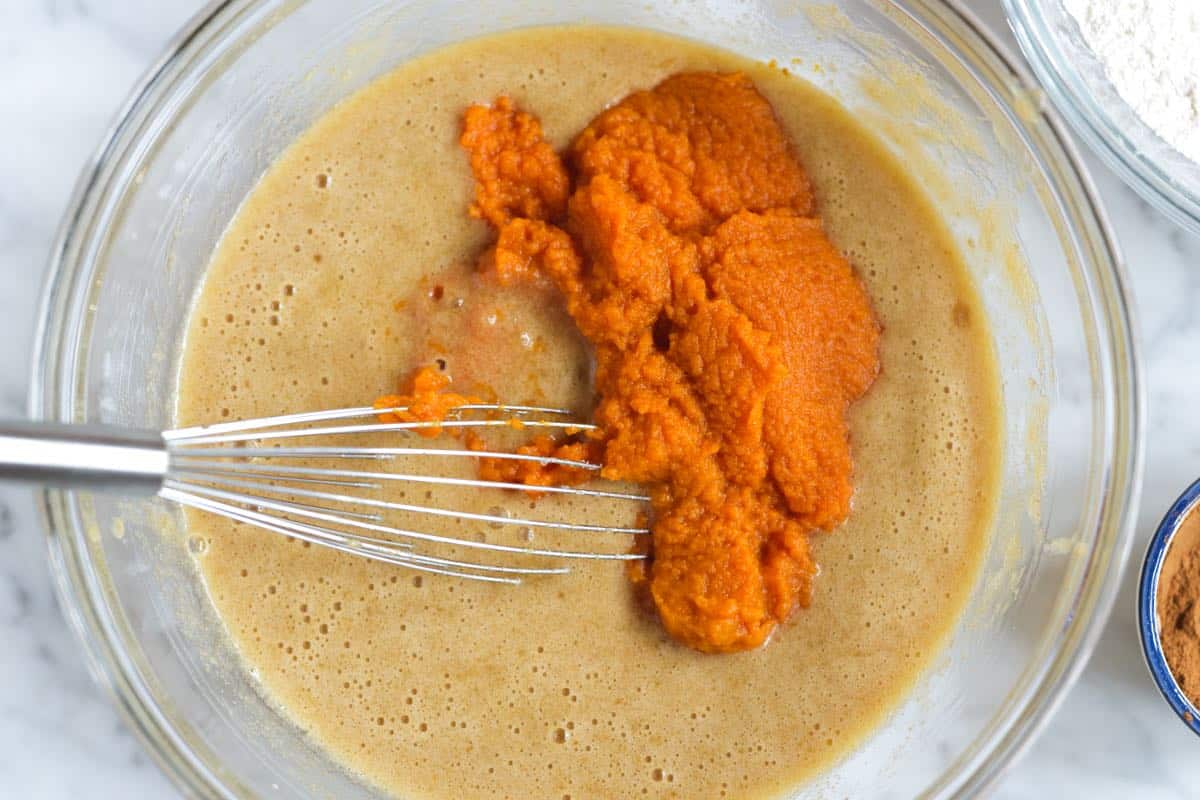 Mixing pumpkin puree into muffin batter by hand