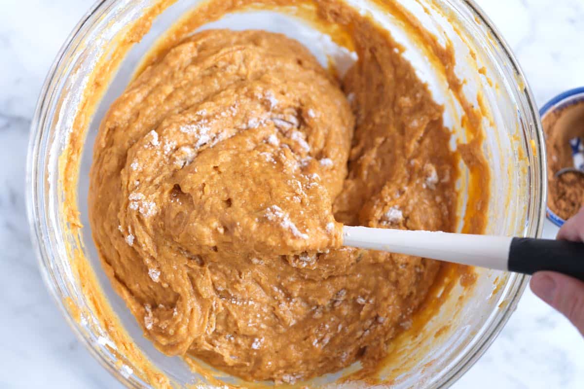 Folding dry and wet ingredients together for the pumpkin muffin batter
