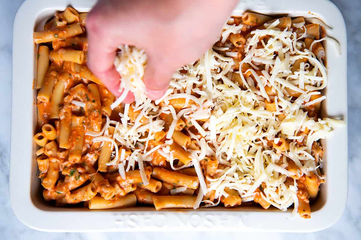 Adding cheese on top of ziti before baking