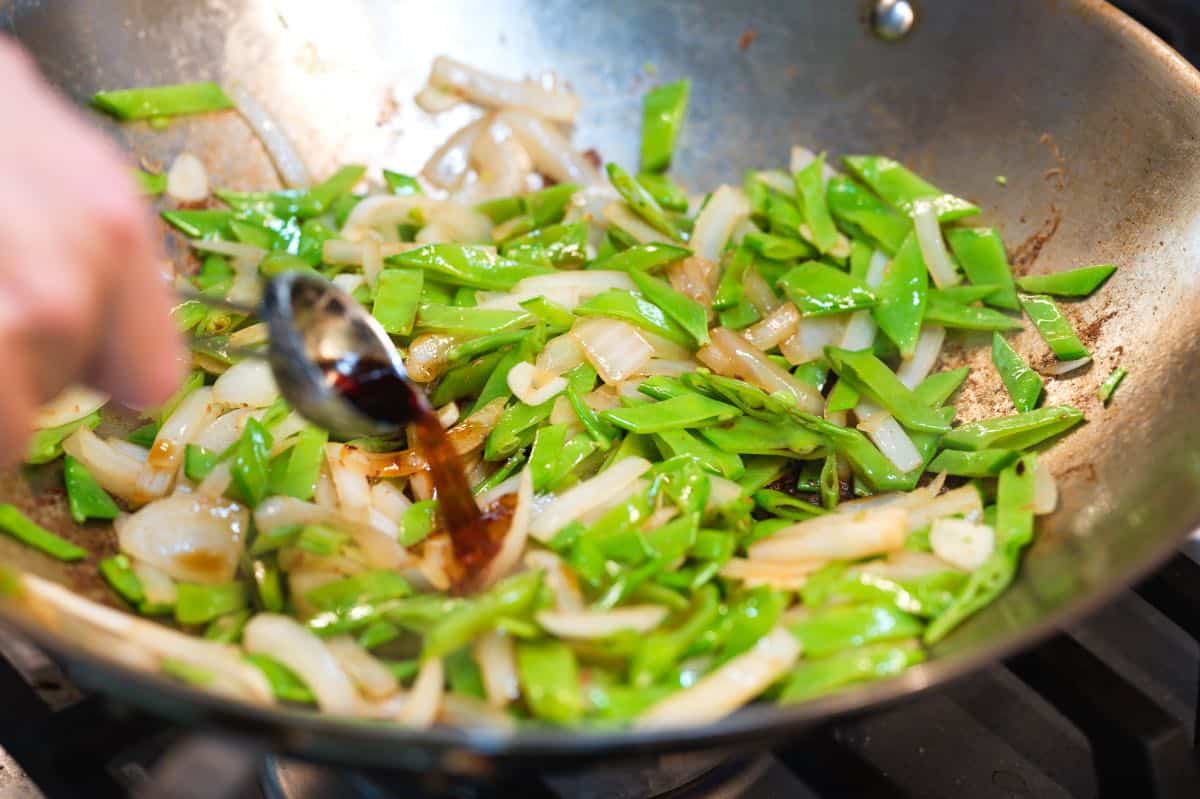 Adding sauce to the stir fry