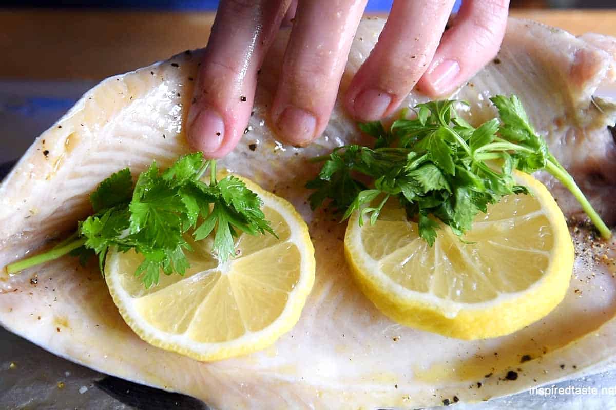 Stuffing trout with lemon and herbs