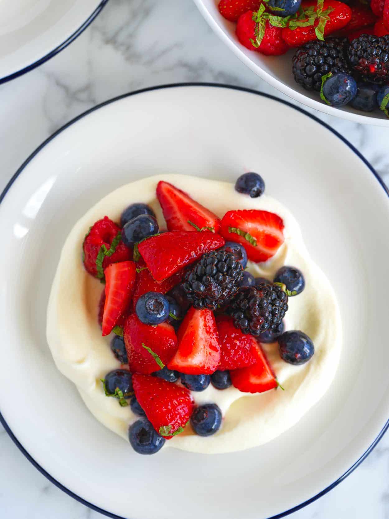 Berry Salad served on top of whipped cream