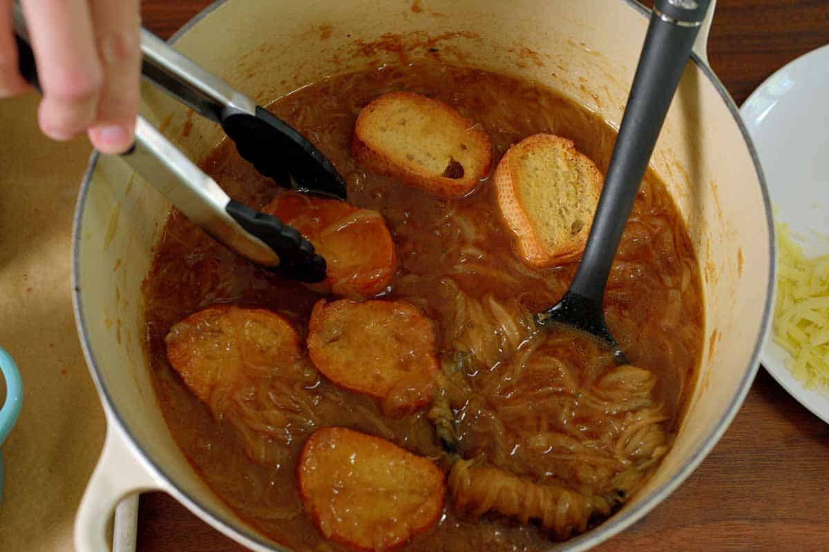 Dunking garlic bread in French onion soup