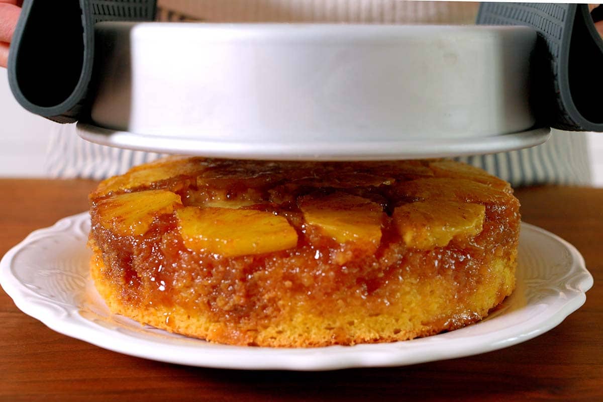 Flipping pineapple upside down cake