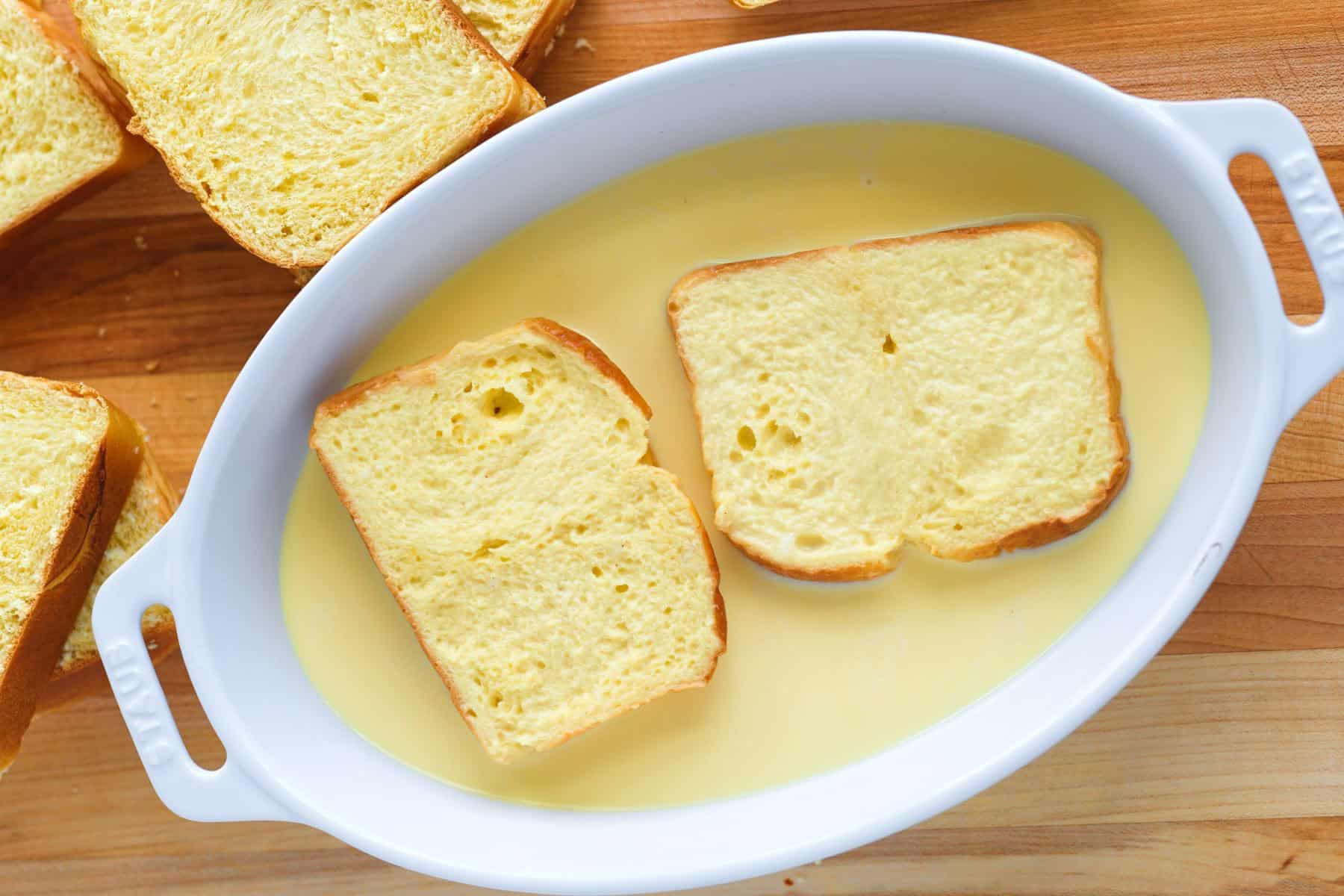 Soaking bread slices in custard