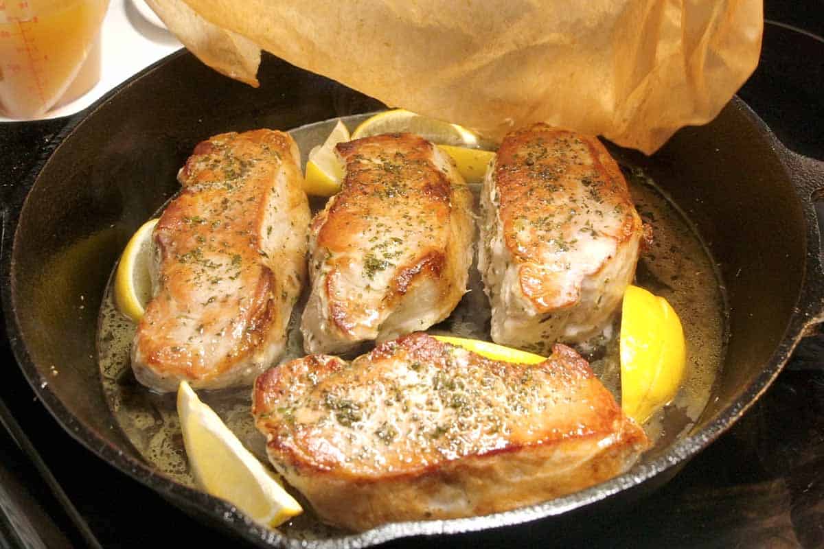 Covering the pork chops before baking them in the oven