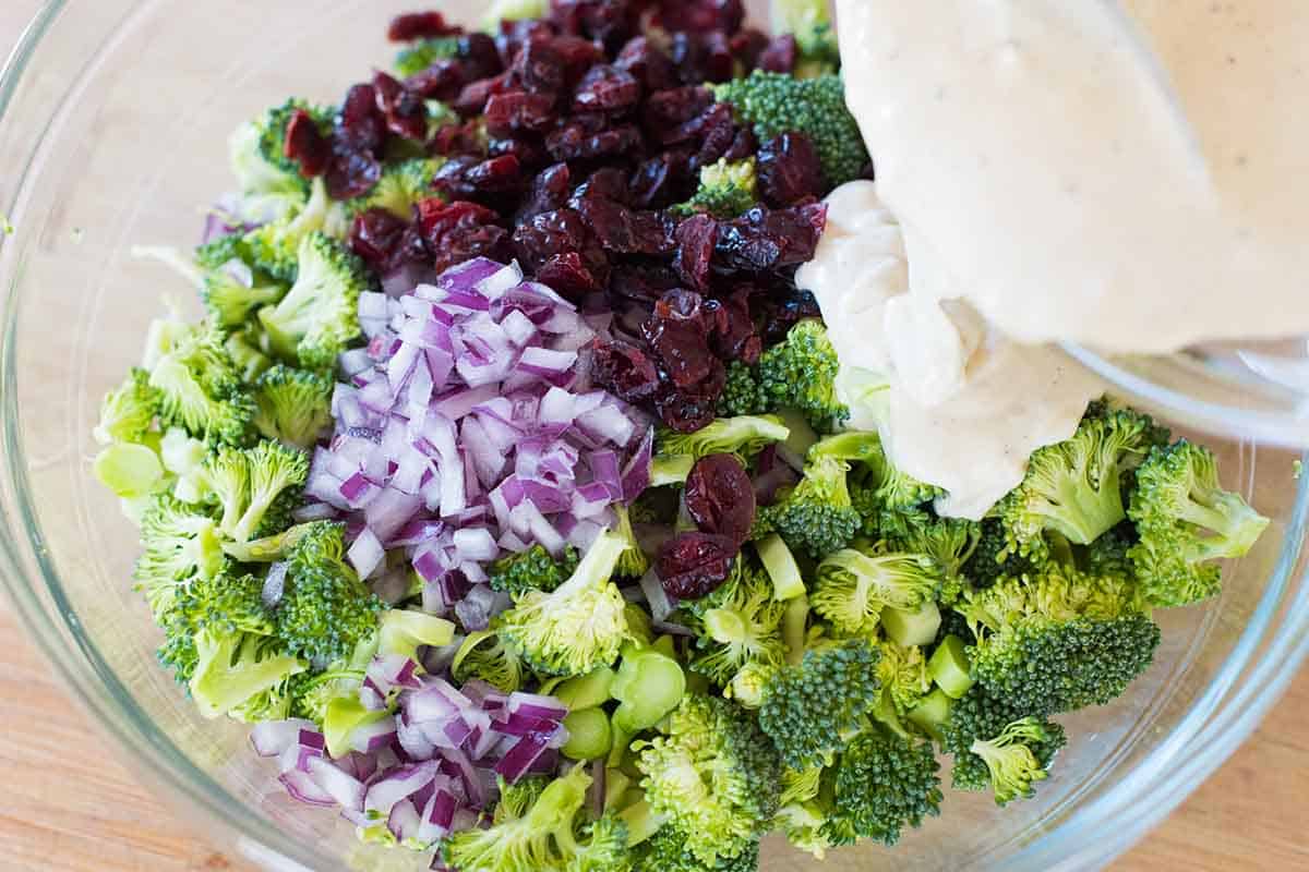 Pouring dressing to make broccoli salad