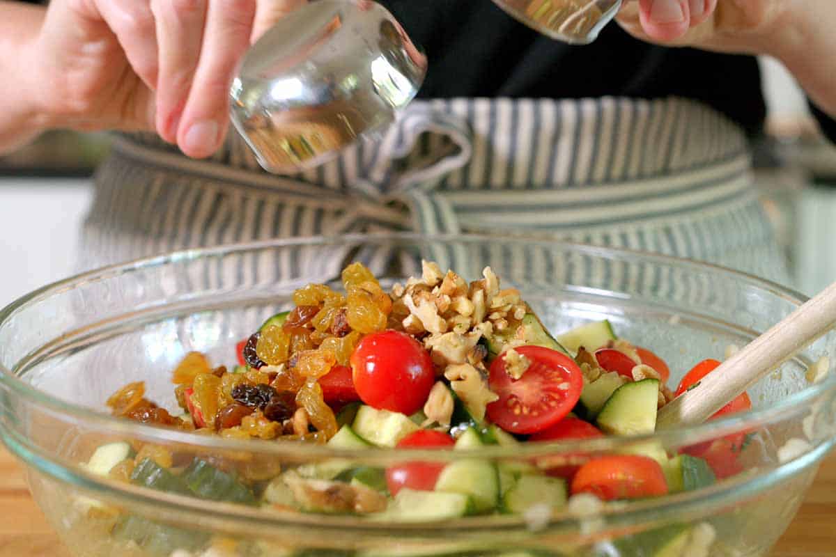 Adding raisins and nuts to couscous salad for texture