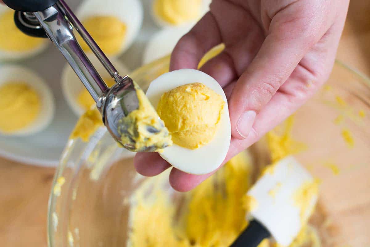 Fill egg white halves with deviled eggs filling using a small cookie scoop