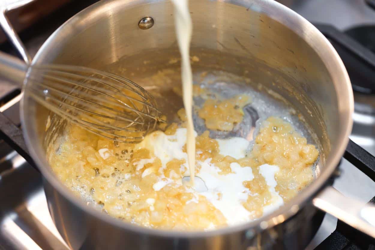 Cooking onions, butter, and flour for the base of the creamy scalloped potatoes sauce