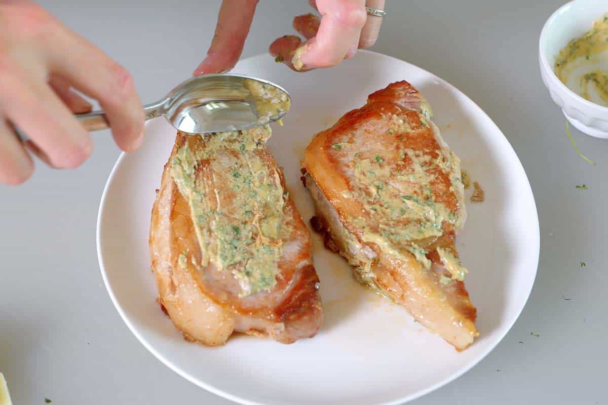 Adding mustard rub to pork chops