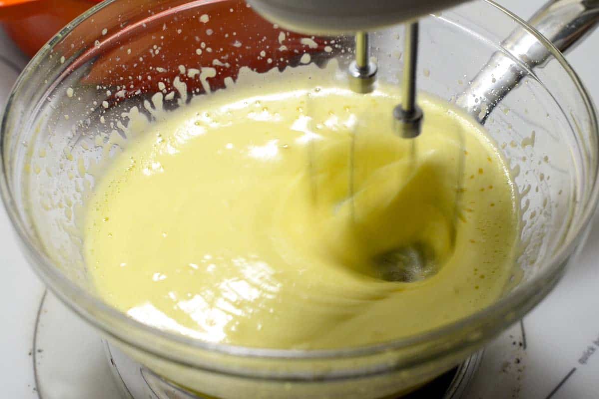Beating egg yolks, Marsala wine, and sugar in a double boiler for the tiramisu filling
