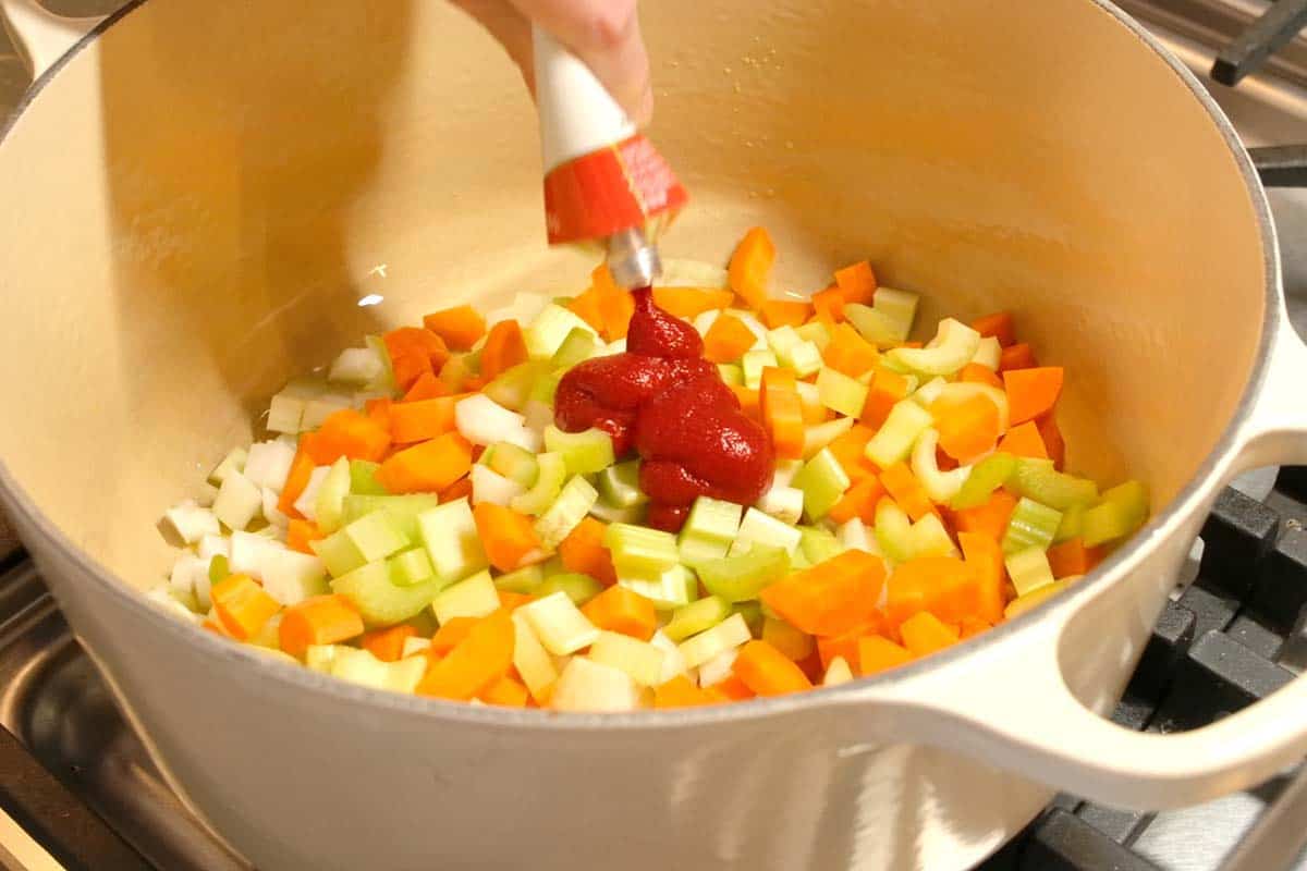 Adding tomato paste to vegetable soup ingredients