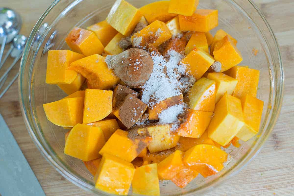 Adding spices and brown sugar to butternut squash
