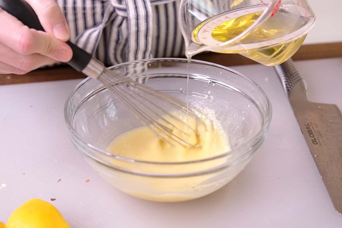 Making Caesar dressing by hand.