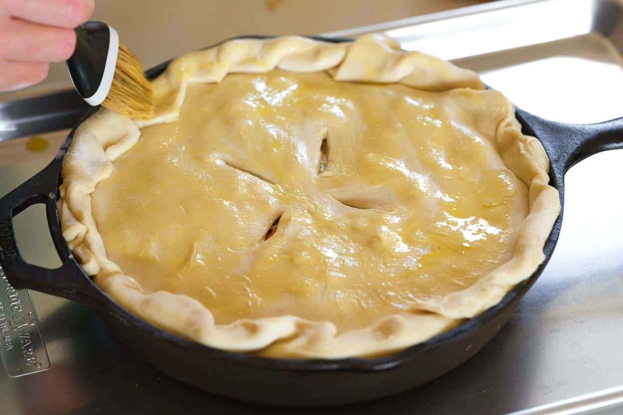 Brushing egg wash over the top puff pastry crust