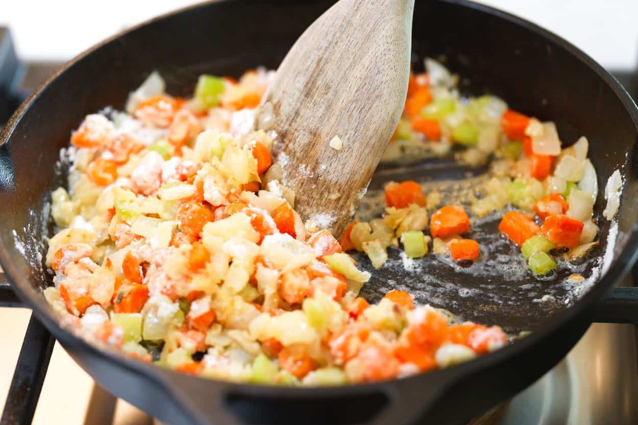 Making chicken pot pie filling with classic vegetables, butter, and flour