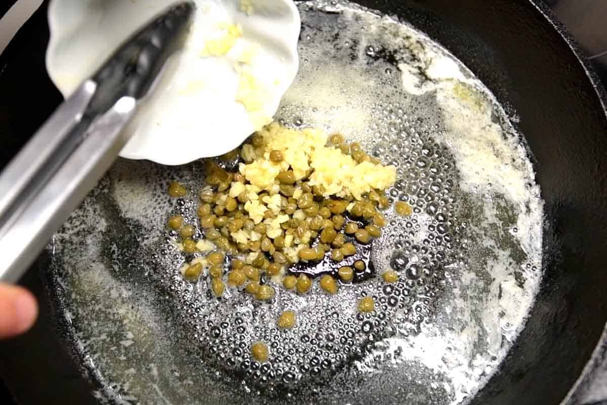 Making garlic caper butter sauce before adding the salmon.