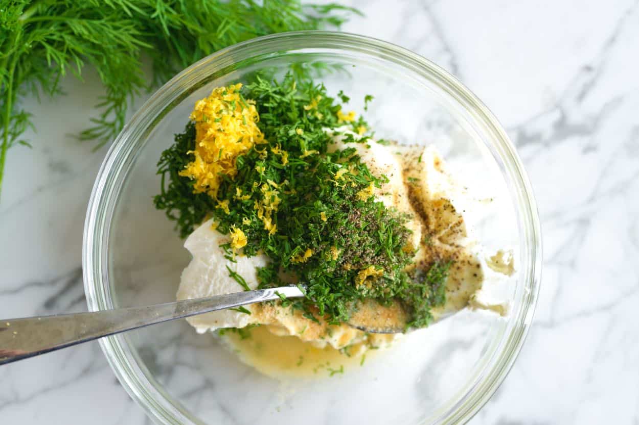 Ingredients for dill sauce in a bowl ready to stir.