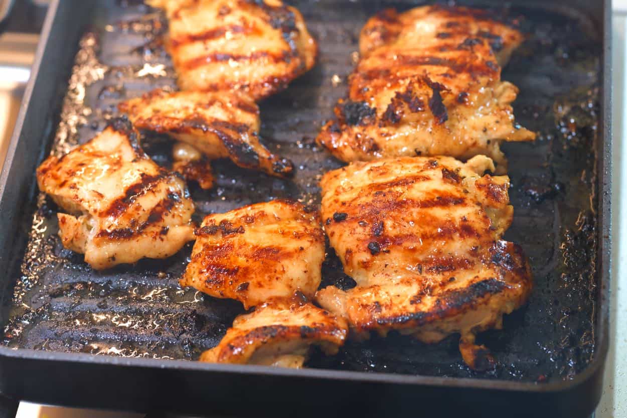 Grilling marinated chicken in a grill pan on the stovetop
