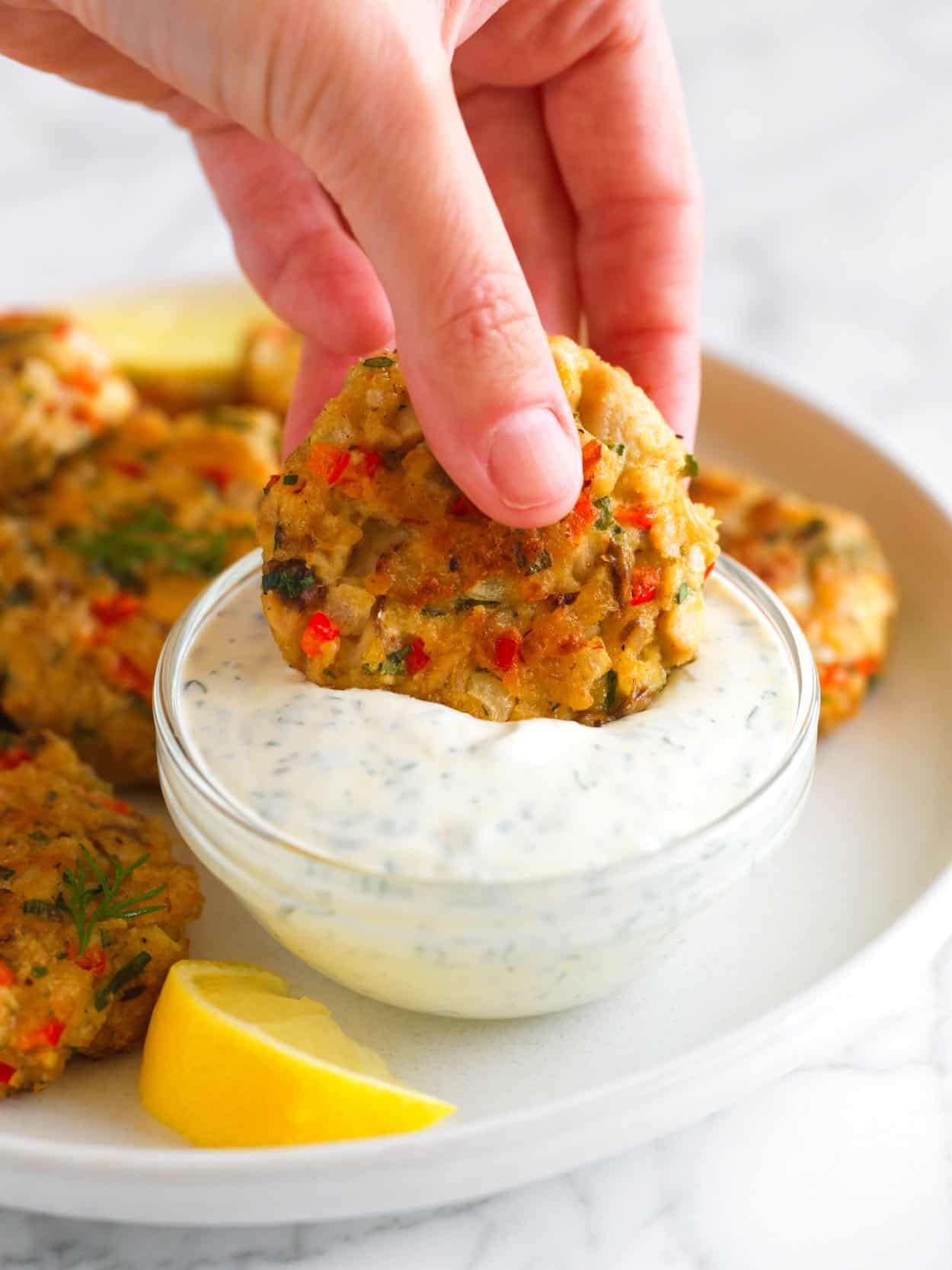 Dipping Salmon Patties into Dill Sauce