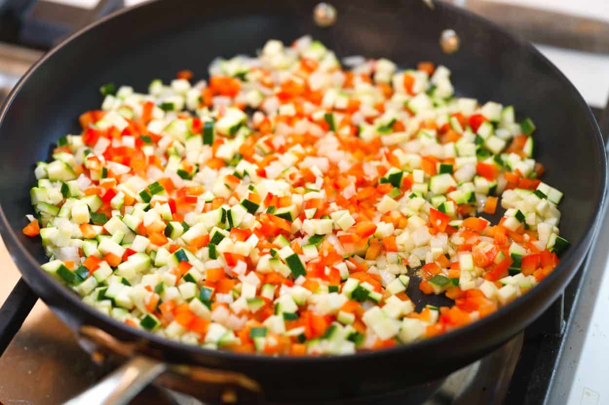 Finely chopped vegetables in a skillet.