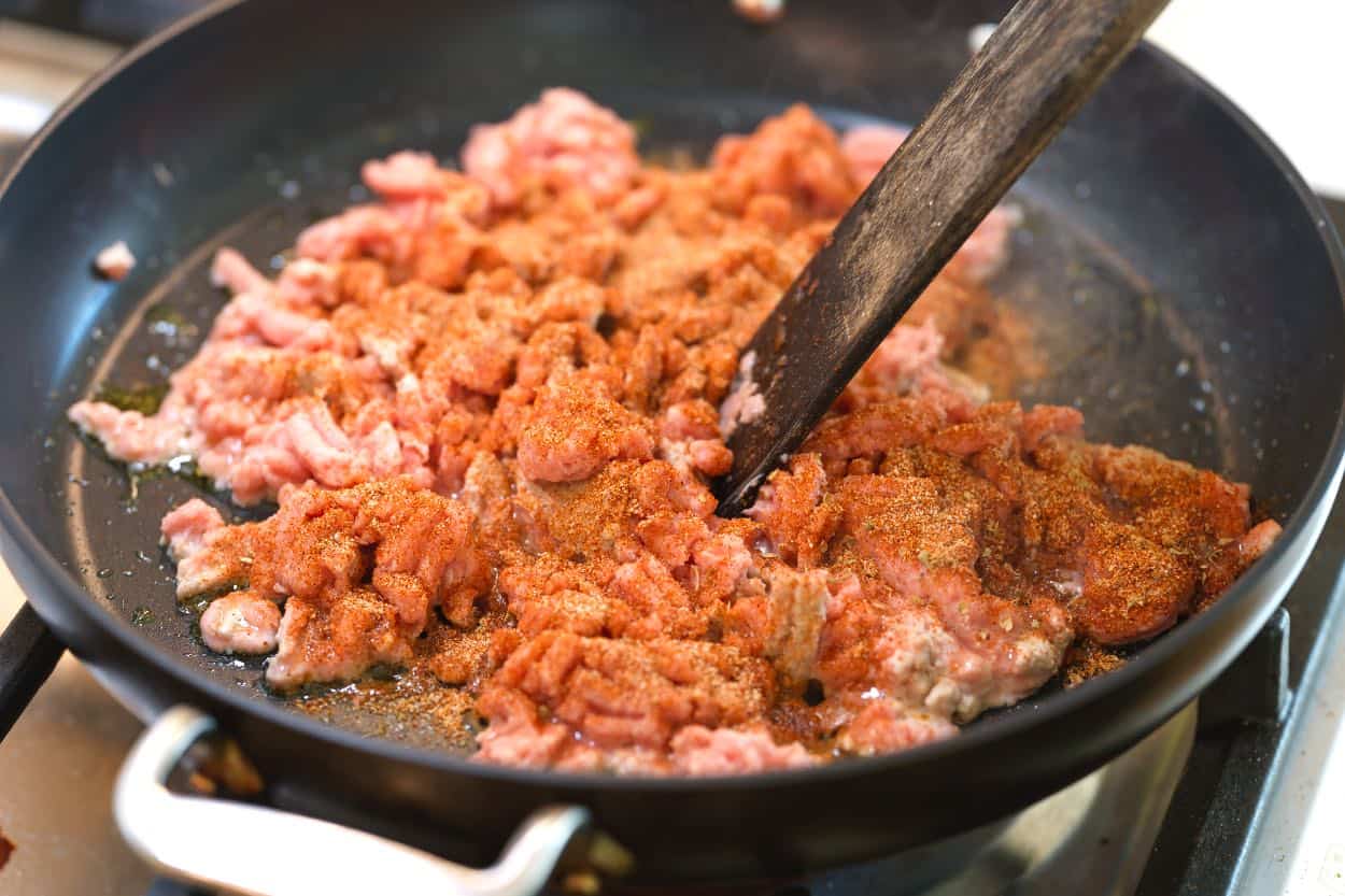 Cooking ground turkey with tacos seasoning in a skillet