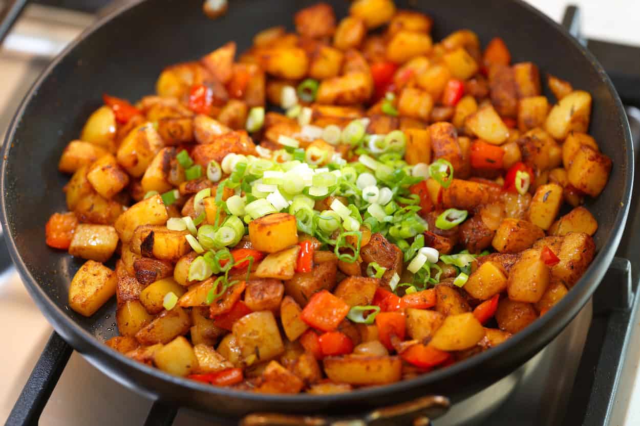The breakfast potatoes are almost done. Adding green onion in the last minute before serving.