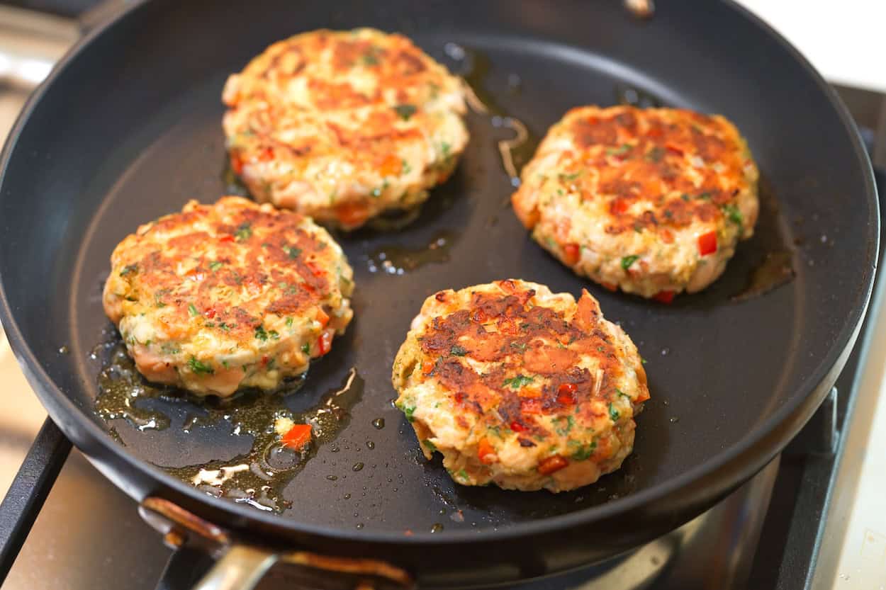Browning the burgers in a skillet before finishing them in the oven