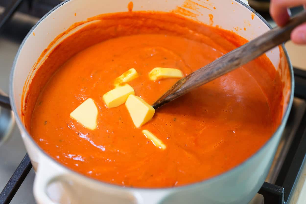 Adding butter to the butter chicken sauce