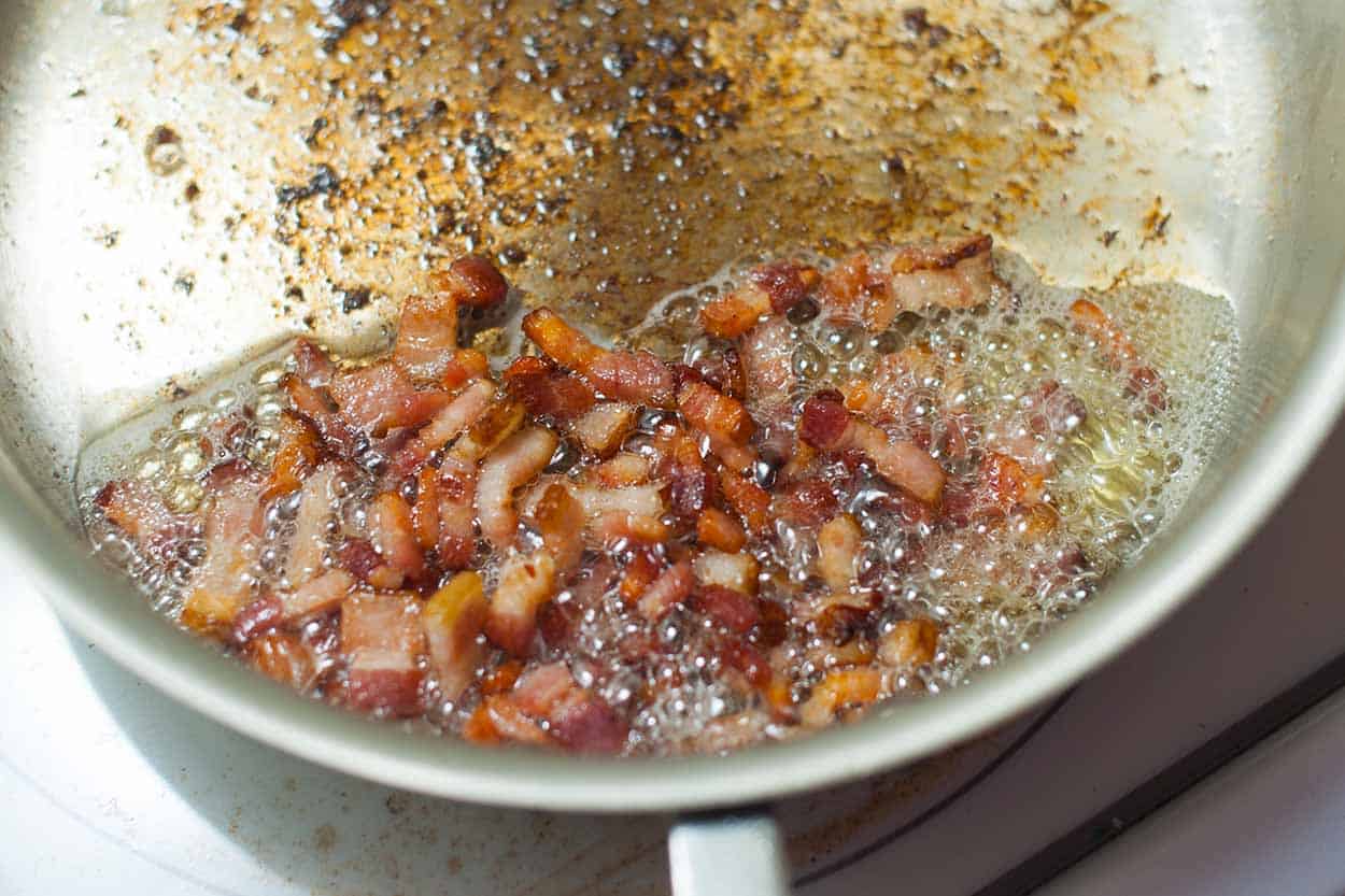 Cooking bacon for the base of the yogurt pasta sauce