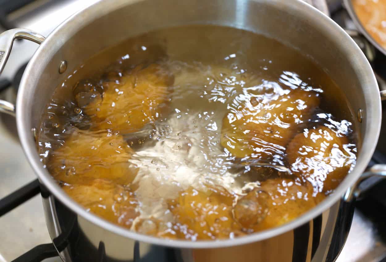 Simmering Yukon Gold potatoes whole in salted water for potato salad