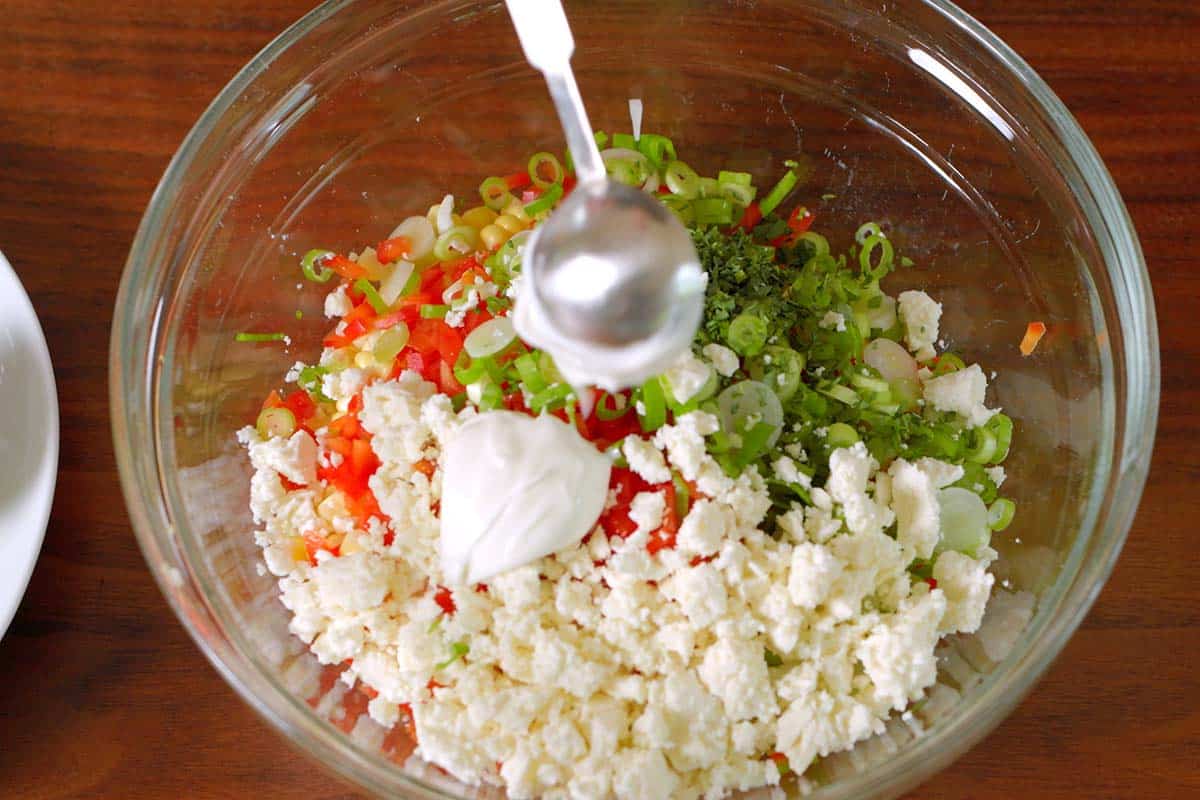 Adding sour cream to the salad