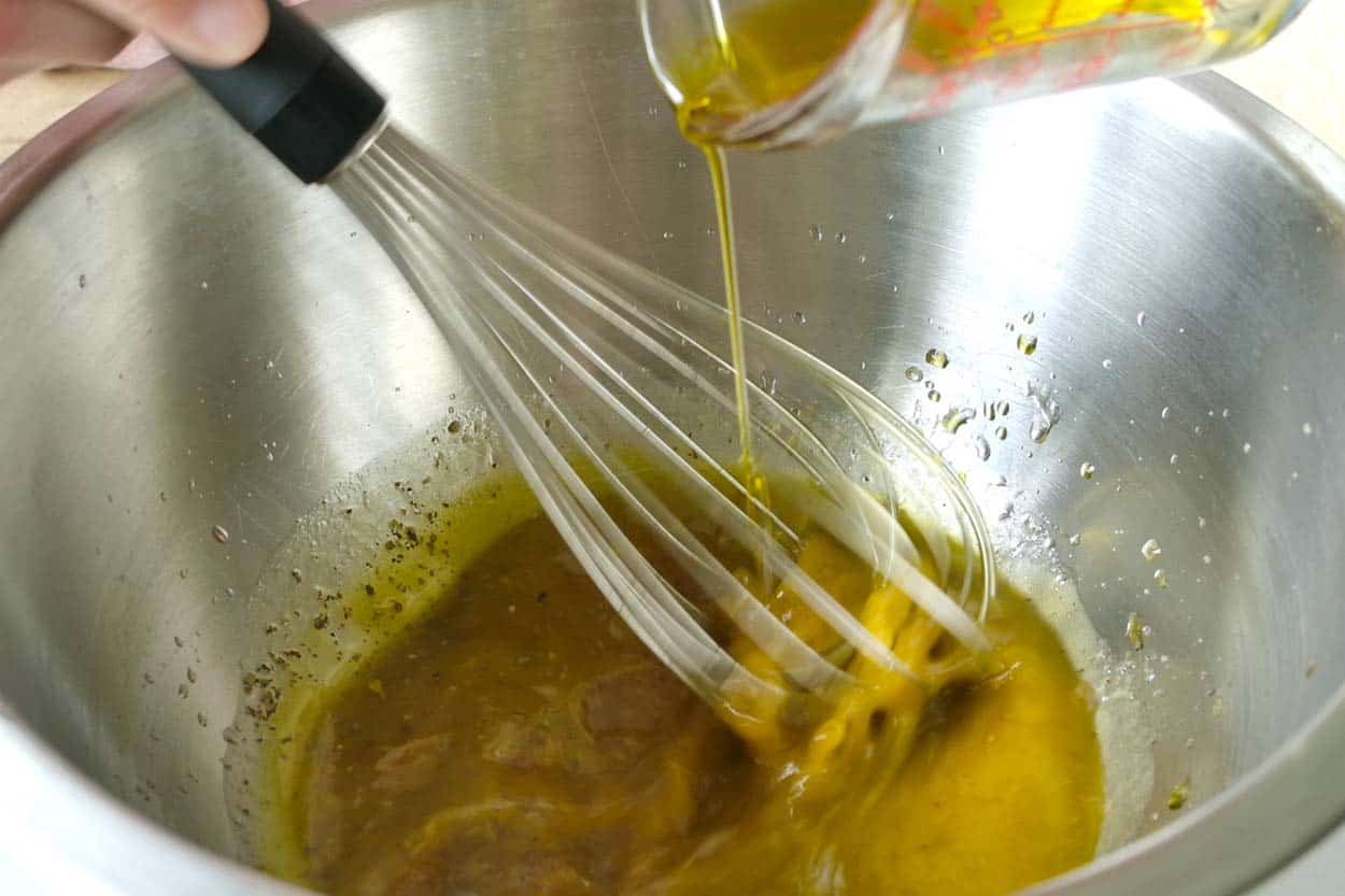 Making the dressing for pasta salad in a big bowl
