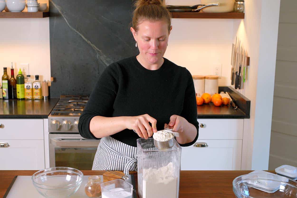 Spooning and leveling flour in a measuring cup